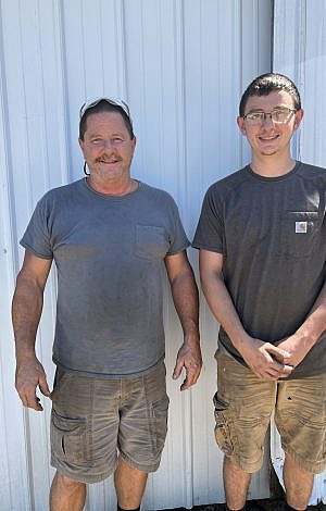 Two men standing side by side smiling